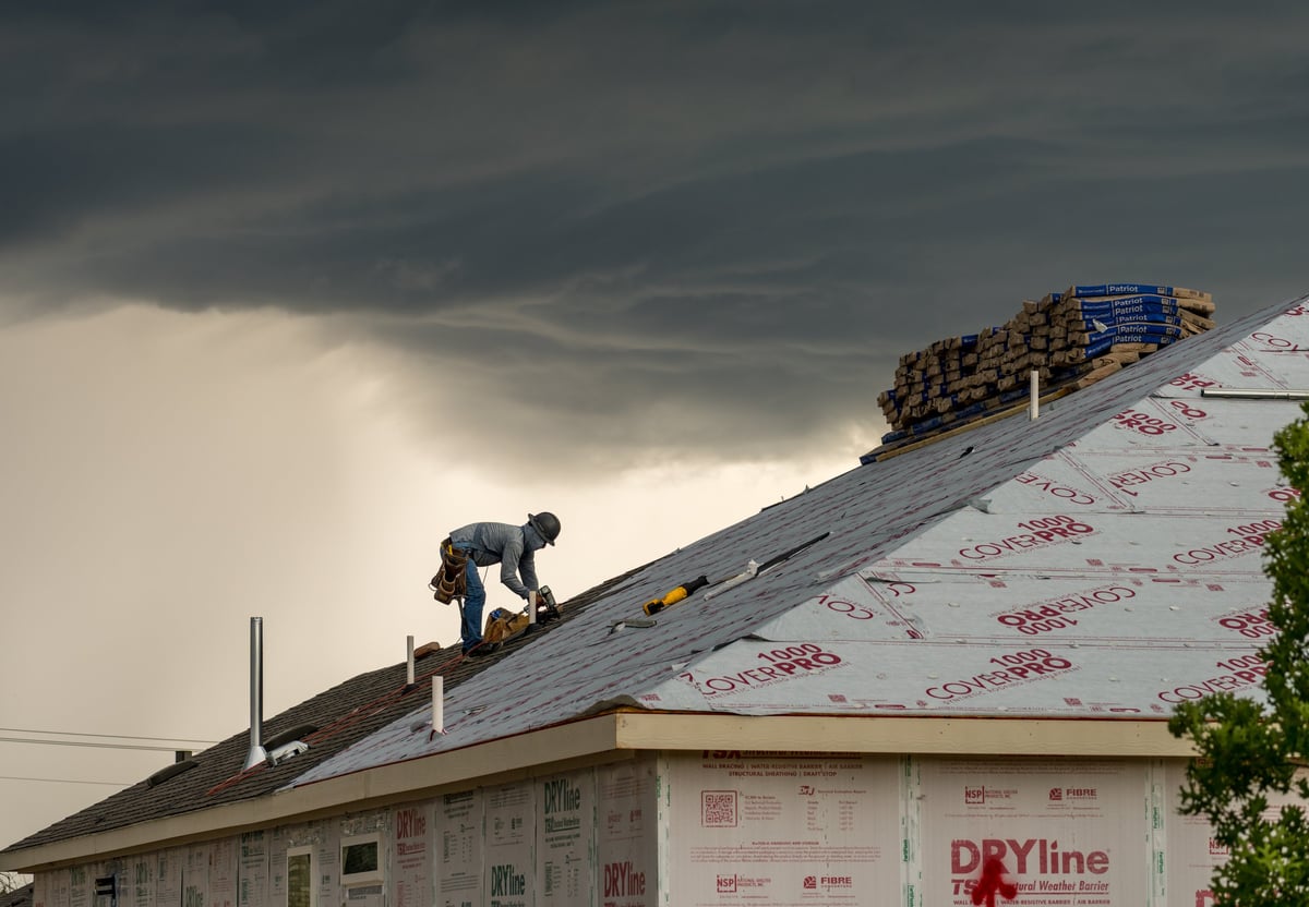 Professional roofers installing a slate roof